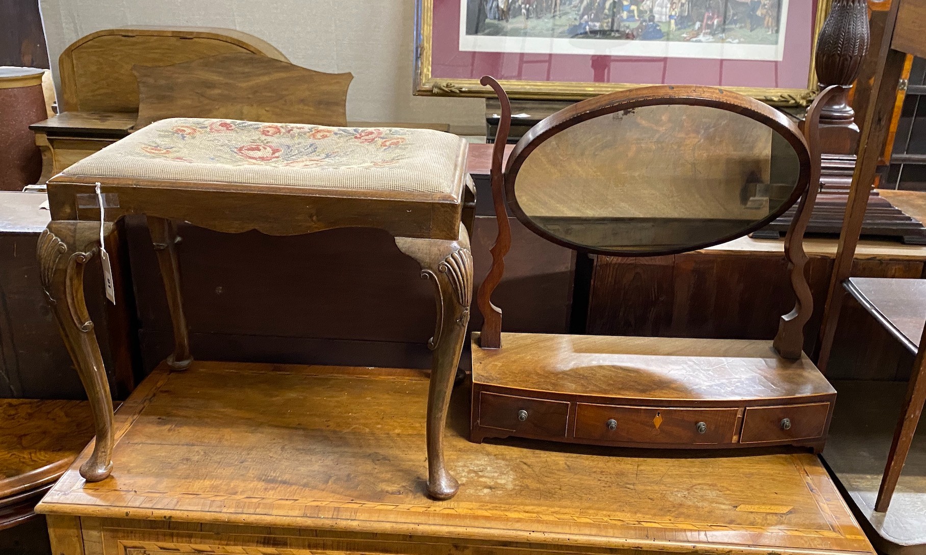 A Queen Anne Revival walnut dressing stool, width 57cm, height 46cm together with a Regency mahogany bow front toilet mirror